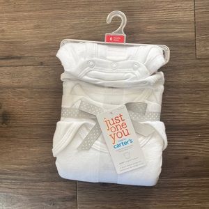 Six months white onesies from Carter’s